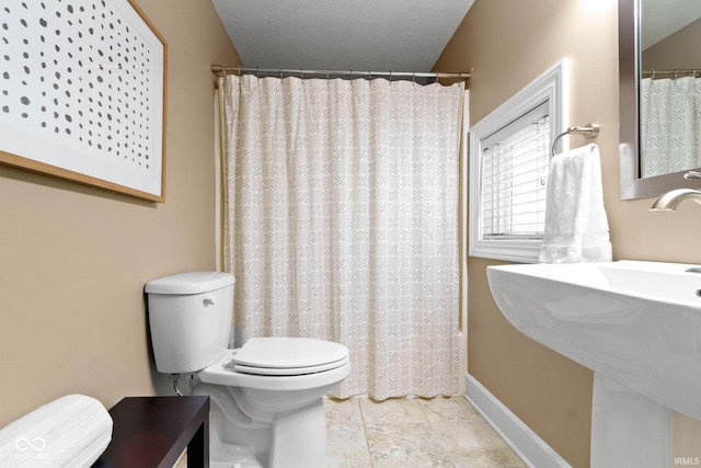 10919 Running Tide Ct, Indianapolis, IN 46236 - bathroom featuring toilet, shower / tub combo with curtain, and baseboards