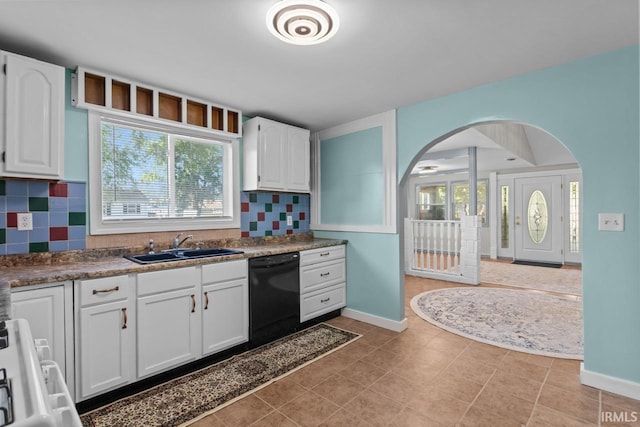 2545 N Bell St, Kokomo, IN 46901 - kitchen with black dishwasher, arched walkways, white cabinets, decorative backsplash, and baseboards