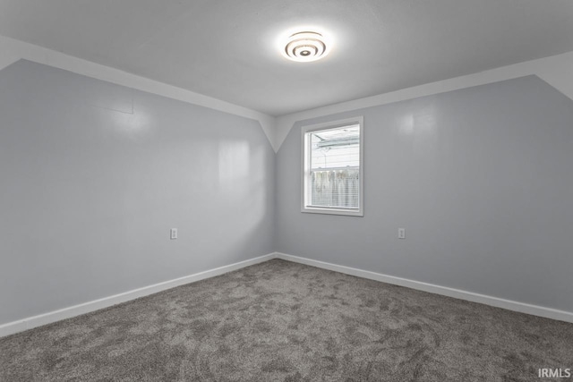 2545 N Bell St, Kokomo, IN 46901 - carpeted empty room with vaulted ceiling and baseboards