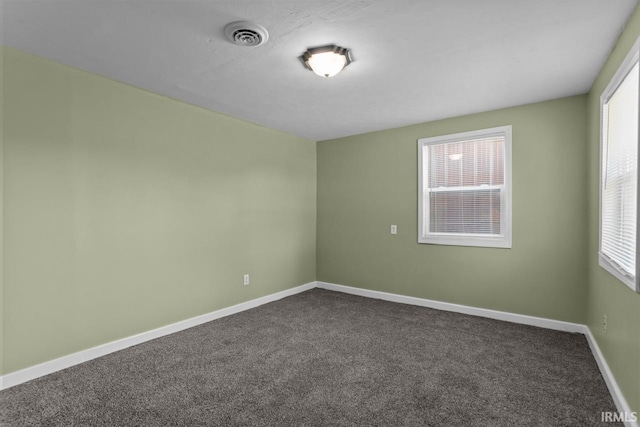 2545 N Bell St, Kokomo, IN 46901 - unfurnished room featuring plenty of natural light, dark carpet, and baseboards