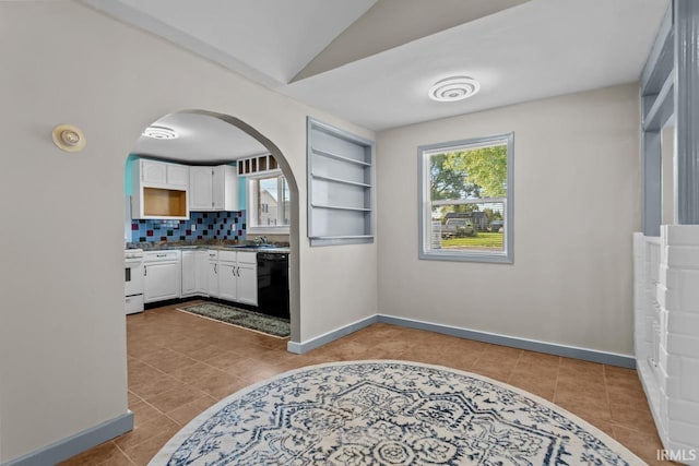 2545 N Bell St, Kokomo, IN 46901 - kitchen featuring dishwasher, white gas range oven, white cabinets, plenty of natural light, and lofted ceiling