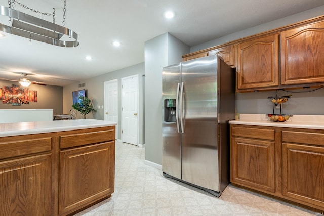 687 N Deer Lake Dr, Bloomfield, IN 47424 - kitchen with stainless steel fridge, light floors, brown cabinetry, recessed lighting, and light countertops