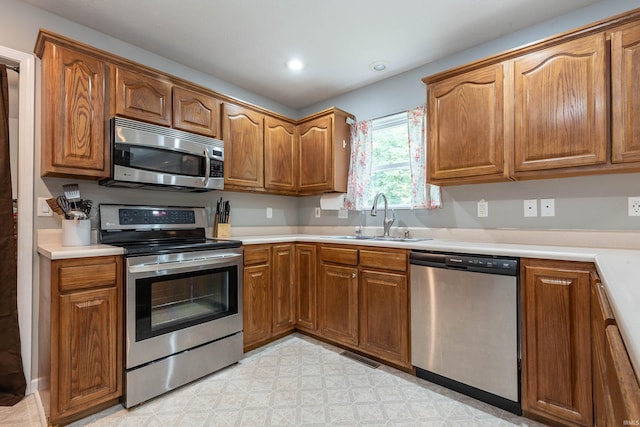 687 N Deer Lake Dr, Bloomfield, IN 47424 - kitchen featuring appliances with stainless steel finishes, a sink, brown cabinets, light countertops, and recessed lighting