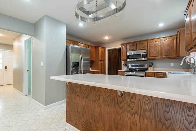 687 N Deer Lake Dr, Bloomfield, IN 47424 - kitchen featuring appliances with stainless steel finishes, a sink, a peninsula, light countertops, and recessed lighting