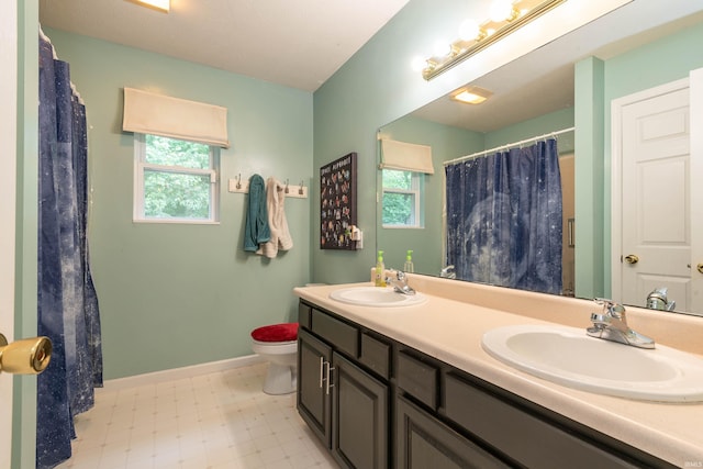 687 N Deer Lake Dr, Bloomfield, IN 47424 - full bath with healthy amount of natural light, toilet, double vanity, and baseboards