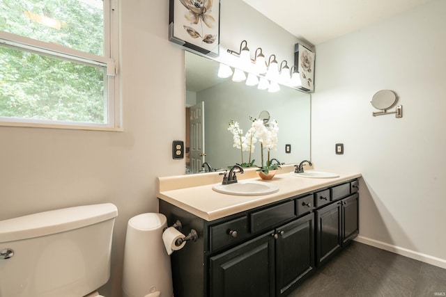 687 N Deer Lake Dr, Bloomfield, IN 47424 - bathroom with toilet, double vanity, and baseboards