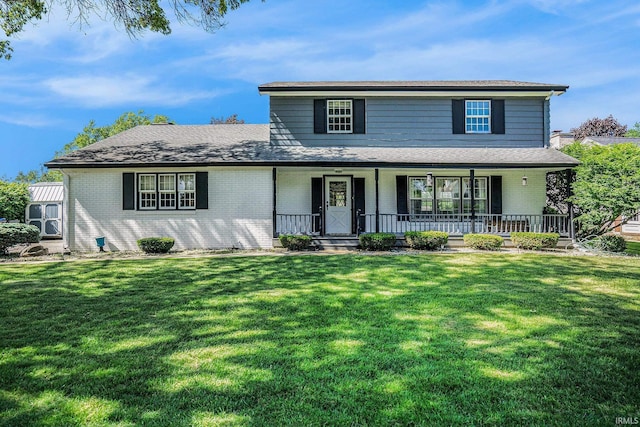 23337 Shorelane, Elkhart, IN 46514 - traditional home with brick siding, a front lawn, covered porch, and roof with shingles