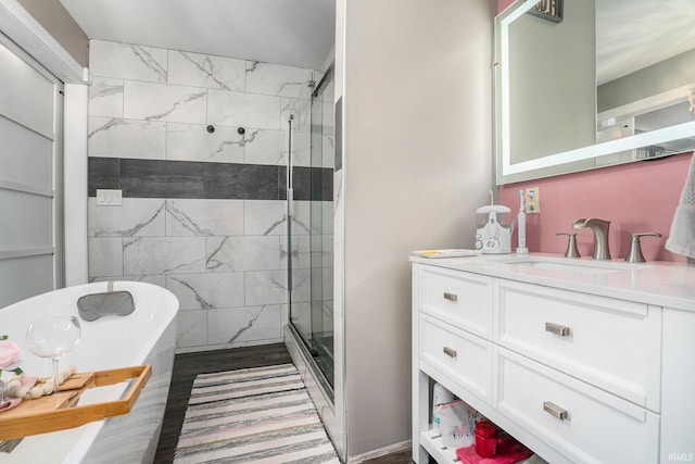23337 Shorelane, Elkhart, IN 46514 - full bath featuring a shower stall, vanity, a freestanding tub, and wood finished floors