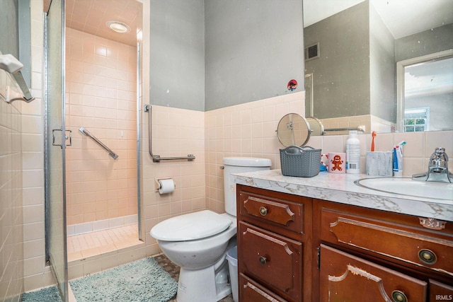 23337 Shorelane, Elkhart, IN 46514 - bathroom with tile walls, toilet, vanity, and a stall shower