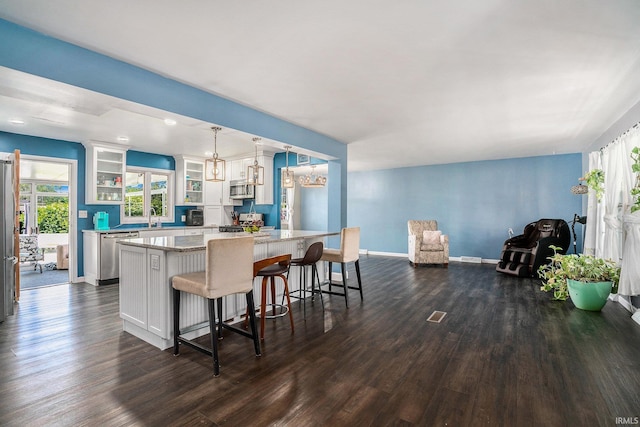 23337 Shorelane, Elkhart, IN 46514 - kitchen featuring appliances with stainless steel finishes, dark wood-style flooring, white cabinetry, and glass insert cabinets