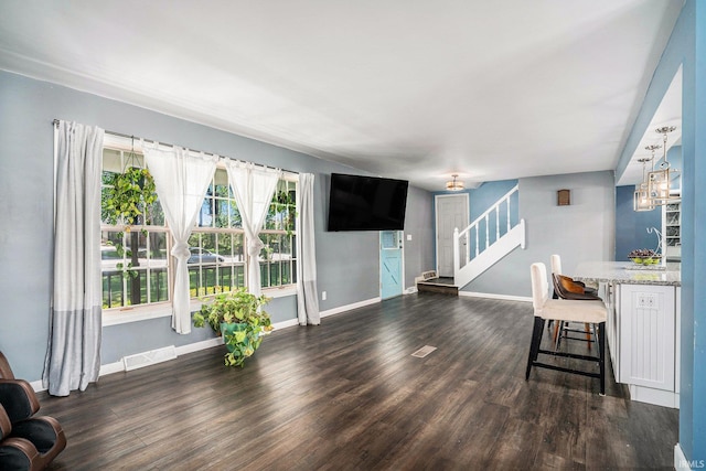 23337 Shorelane, Elkhart, IN 46514 - unfurnished living room featuring stairs, dark wood-style flooring, and baseboards