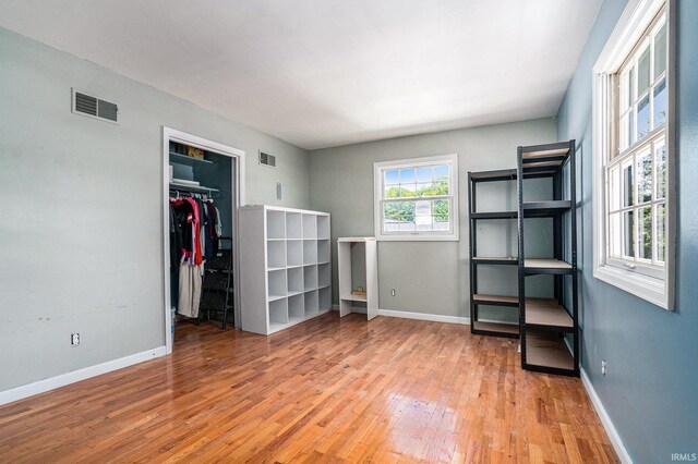 23337 Shorelane, Elkhart, IN 46514 - unfurnished bedroom with wood finished floors, baseboards, a spacious closet, and a closet