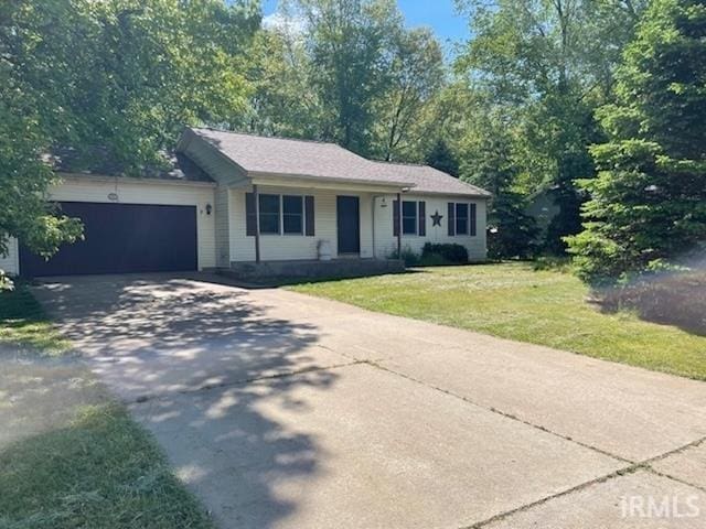 56862 Pomona St, Elkhart, IN 46516 - single story home with a garage, concrete driveway, and a front lawn
