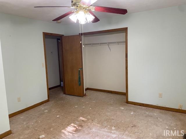56862 Pomona St, Elkhart, IN 46516 - unfurnished bedroom with baseboards, a closet, and ceiling fan