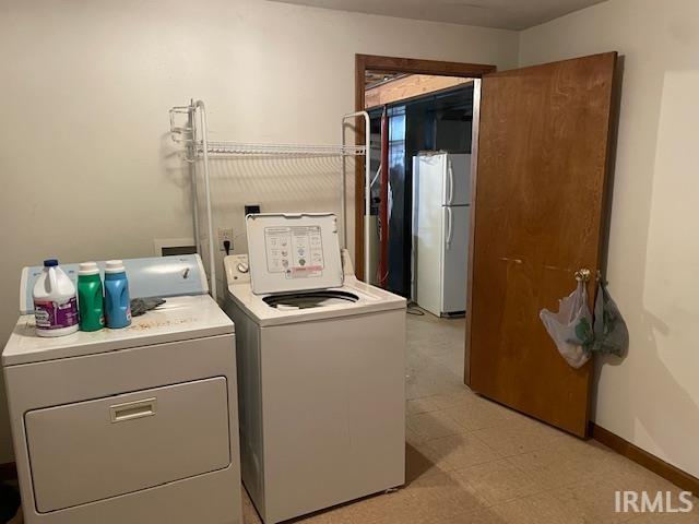 56862 Pomona St, Elkhart, IN 46516 - laundry area with washer and dryer, light flooring, and baseboards