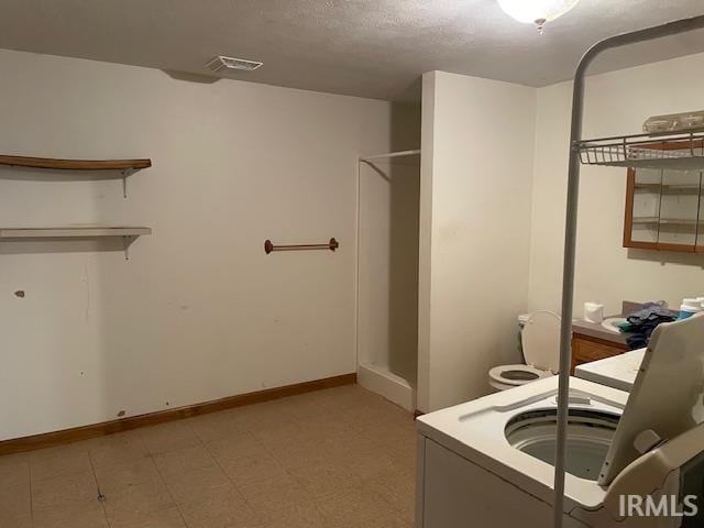 56862 Pomona St, Elkhart, IN 46516 - bathroom with a shower, baseboards, and a textured ceiling