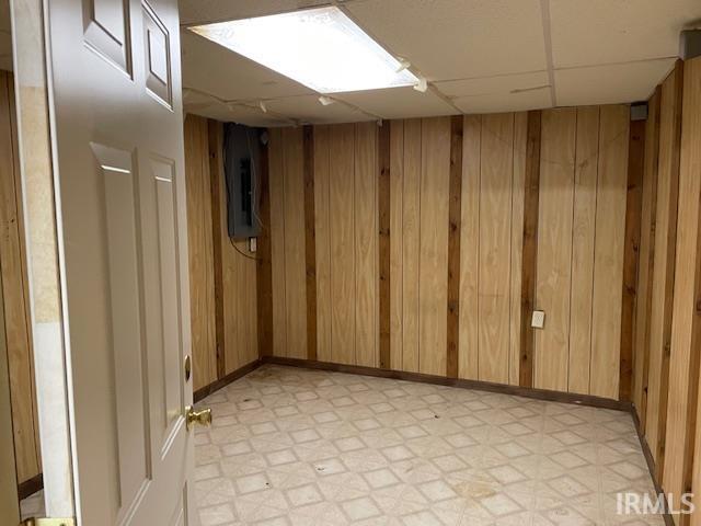 56862 Pomona St, Elkhart, IN 46516 - unfurnished room with light flooring, wooden walls, and a drop ceiling