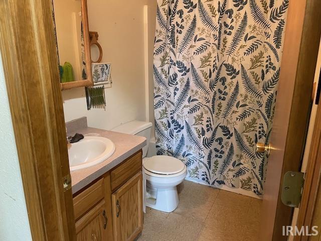 56862 Pomona St, Elkhart, IN 46516 - bathroom featuring vanity, toilet, and a shower with curtain