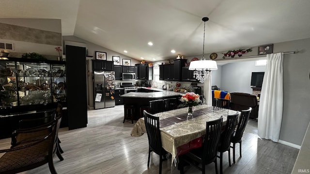 1237 Northstone Rd, Goshen, IN 46526 - dining area featuring light wood-style floors, recessed lighting, and vaulted ceiling