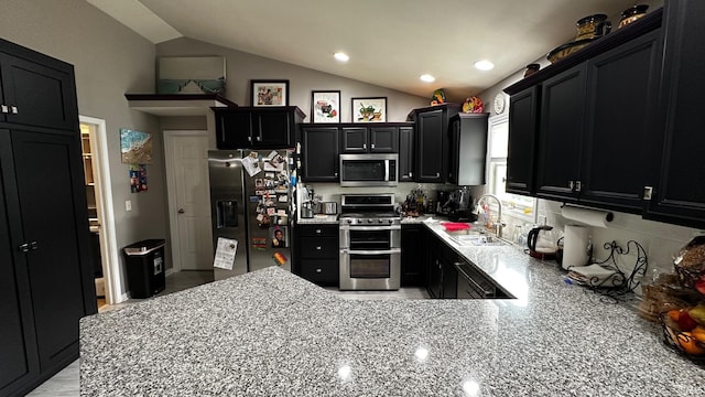 1237 Northstone Rd, Goshen, IN 46526 - kitchen featuring appliances with stainless steel finishes, a sink, dark cabinets, vaulted ceiling, and recessed lighting