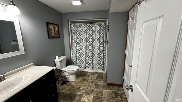 1237 Northstone Rd, Goshen, IN 46526 - full bath with vanity, toilet, stone finish floors, baseboards, and curtained shower