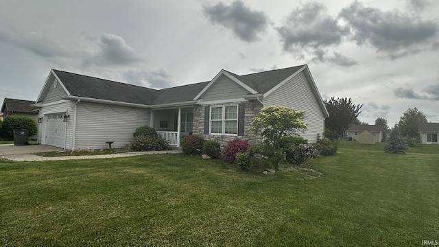1237 Northstone Rd, Goshen, IN 46526 - view of front of property with a garage, a front yard, stone siding, concrete driveway, and covered porch