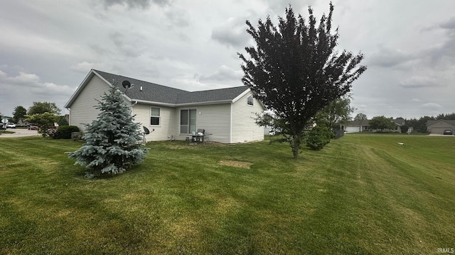 1237 Northstone Rd, Goshen, IN 46526 - view of property exterior featuring a lawn and a shingled roof