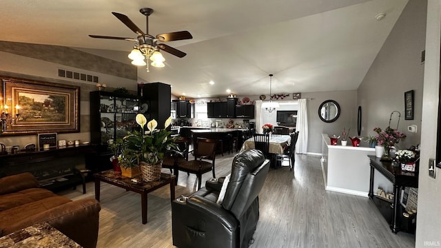 1237 Northstone Rd, Goshen, IN 46526 - living area with lofted ceiling, a ceiling fan, wood finished floors, and baseboards