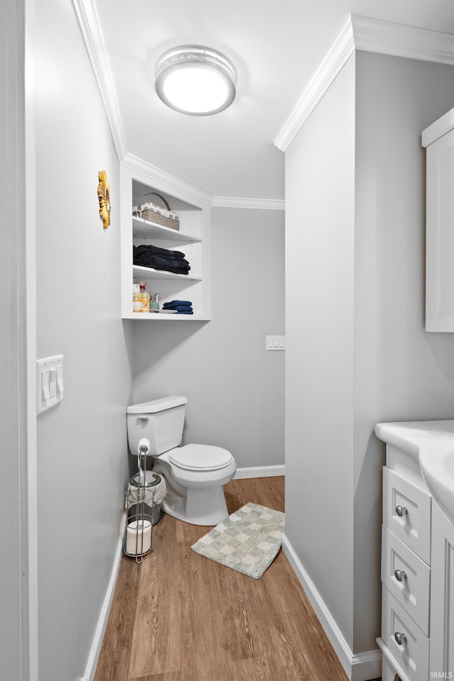 753 W Centennial St, Nappanee, IN 46550 - bathroom featuring wood finished floors, crown molding, toilet, vanity, and baseboards