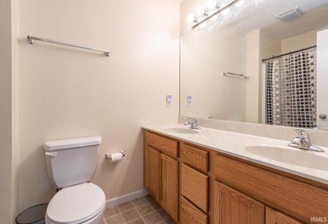 7203 W Capstone Cir, Bloomington, IN 47404 - full bathroom featuring double vanity, baseboards, toilet, and tile patterned floors