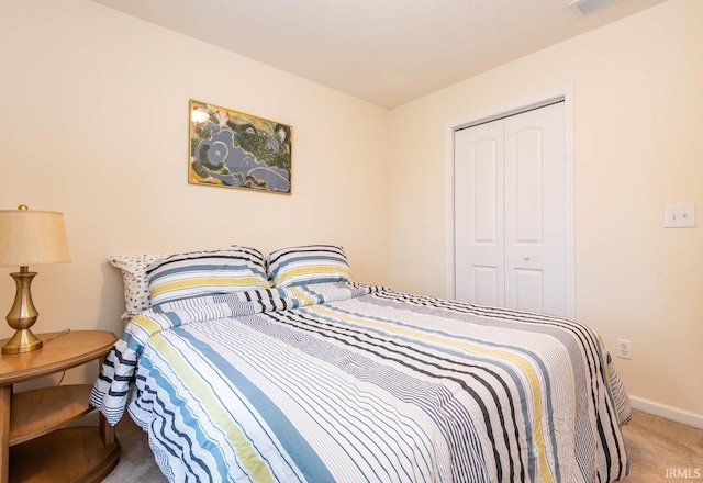 7203 W Capstone Cir, Bloomington, IN 47404 - bedroom featuring a closet, carpet, and baseboards
