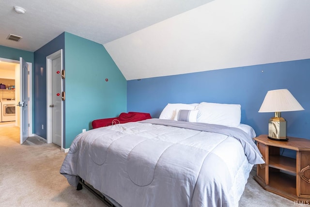 7203 W Capstone Cir, Bloomington, IN 47404 - bedroom with light carpet, washer and dryer, lofted ceiling, and baseboards