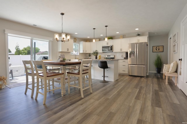 606 W Elm St, Haubstadt, IN 47639 - dining space with recessed lighting, a chandelier, and dark wood-style floors
