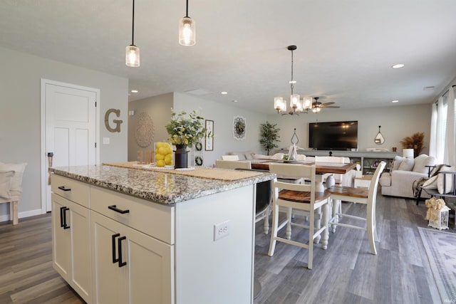 606 W Elm St, Haubstadt, IN 47639 - kitchen with open floor plan, dark wood finished floors, white cabinets, recessed lighting, and a center island