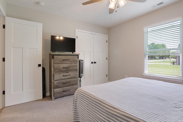 606 W Elm St, Haubstadt, IN 47639 - bedroom featuring multiple windows, light colored carpet, a closet, and ceiling fan