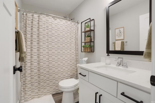 606 W Elm St, Haubstadt, IN 47639 - full bath featuring vanity, toilet, a shower with curtain, and wood finished floors