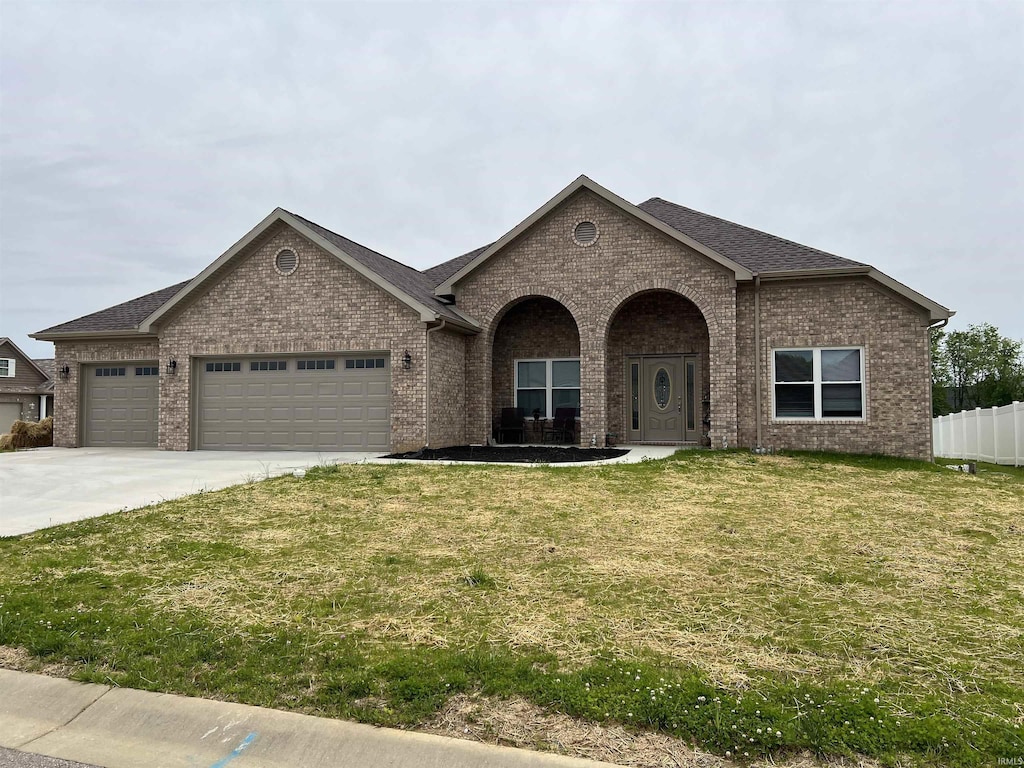 7815 Jt Ct, Evansville, IN 47715 - view of front facade featuring brick siding, a garage, concrete driveway, and roof with shingles