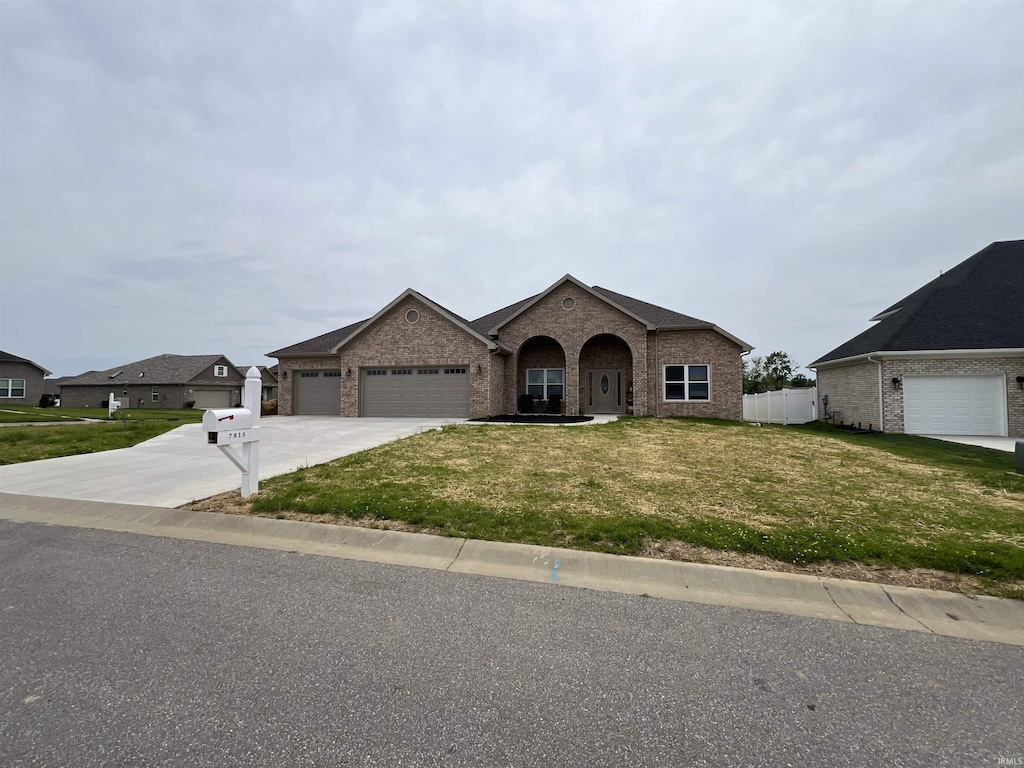 7815 Jt Ct, Evansville, IN 47715 - view of front facade featuring an attached garage, brick siding, and concrete driveway