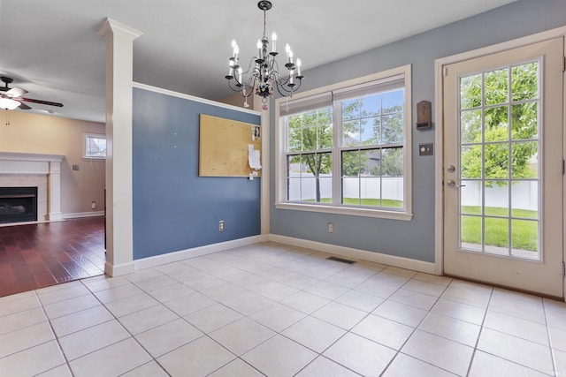 3746 Rolling Rock Dr, Evansville, IN 47711 - unfurnished dining area featuring a tile fireplace, a ceiling fan, a chandelier, baseboards, and tile patterned floors