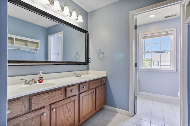 3746 Rolling Rock Dr, Evansville, IN 47711 - bathroom with double vanity, tile patterned floors, toilet, and baseboards