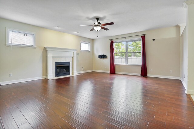 3746 Rolling Rock Dr, Evansville, IN 47711 - unfurnished living room with ceiling fan, a tile fireplace, dark wood-type flooring, and baseboards