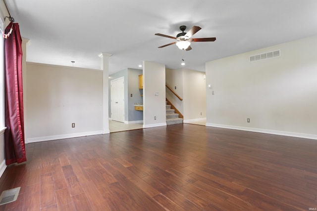 3746 Rolling Rock Dr, Evansville, IN 47711 - unfurnished room featuring ceiling fan, dark wood-type flooring, stairs, baseboards, and decorative columns