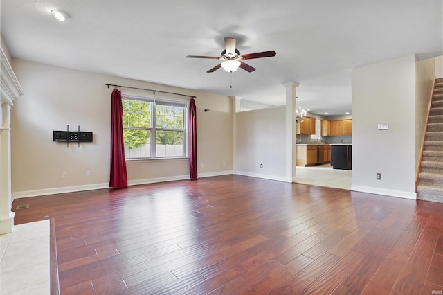 3746 Rolling Rock Dr, Evansville, IN 47711 - unfurnished living room featuring ceiling fan, stairs, ornate columns, wood finished floors, and recessed lighting