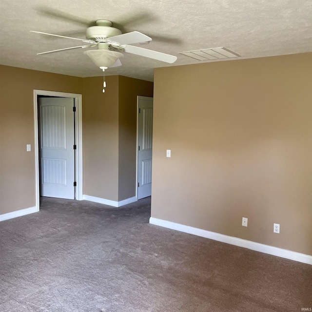 1841 S Patriot Dr, Yorktown, IN 47396 - empty room featuring ceiling fan, dark colored carpet, baseboards, and a textured ceiling