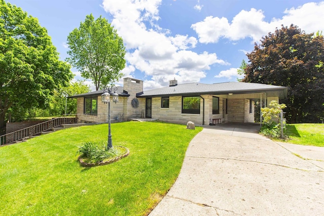 16128 Chandler Blvd, Mishawaka, IN 46544 - view of front of home with stone siding, driveway, a front yard, a carport, and a chimney
