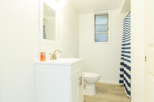 16128 Chandler Blvd, Mishawaka, IN 46544 - bathroom with wood finished floors, toilet, vanity, baseboards, and curtained shower
