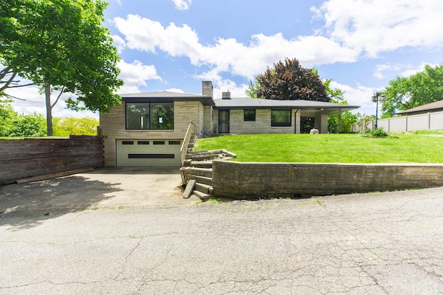 16128 Chandler Blvd, Mishawaka, IN 46544 - view of front of property with an attached garage, driveway, and a chimney