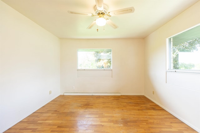 16128 Chandler Blvd, Mishawaka, IN 46544 - empty room featuring a baseboard heating unit, plenty of natural light, light wood-type flooring, and baseboards