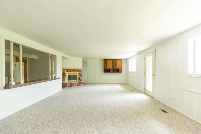 16128 Chandler Blvd, Mishawaka, IN 46544 - unfurnished living room featuring carpet, plenty of natural light, and a fireplace