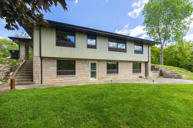 16128 Chandler Blvd, Mishawaka, IN 46544 - rear view of house with stairway, a yard, stone siding, and a patio